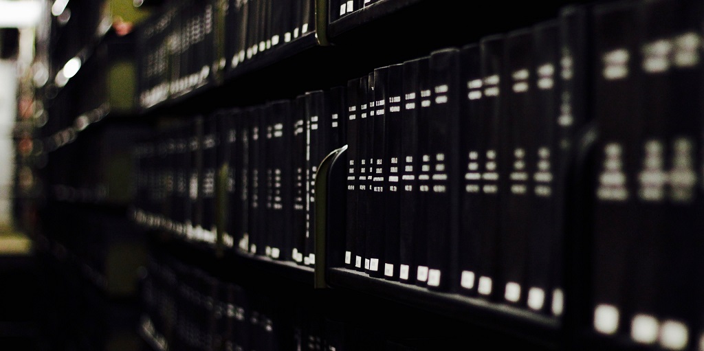 Closeup of book on shelves. Photo credit: jake-lorefice-SylPuraNzUM-unsplash