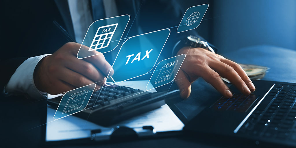 Businessman using the laptop to fill in the income tax online return form for payment. Photo by Miha Creative on Shutterstock, source: hhttps://www.shutterstock.com/image-photo/financial-researchgovernment-taxes-calculation-tax-return-2072821730