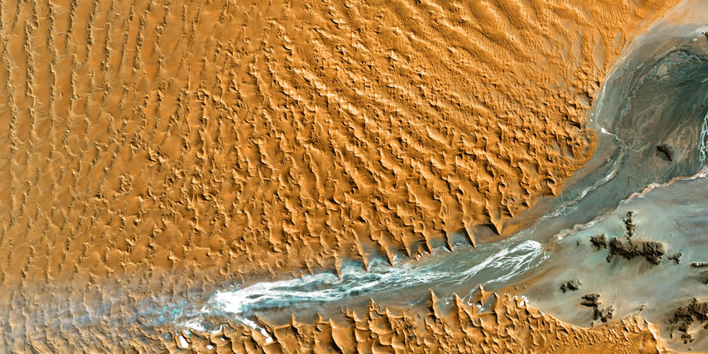 Aerial view of a river running through a desert. Photo by USGS on Unsplash, https://unsplash.com/photos/an-aerial-view-of-a-river-running-through-a-desert-2x4ceLz2yEo