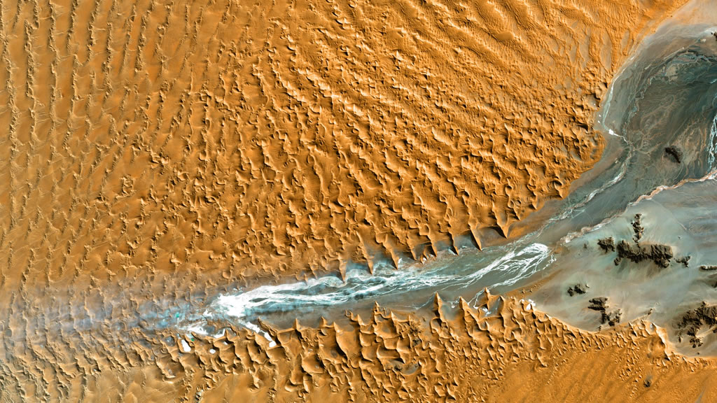 Aerial view of a river running through a desert. Photo by USGS on Unsplash, https://unsplash.com/photos/an-aerial-view-of-a-river-running-through-a-desert-2x4ceLz2yEo